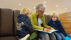 Grandma reading to grandsons